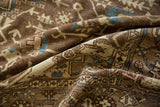 Distressed texture and geometric tendrils on a Karaja rug in coffee brown and blue.