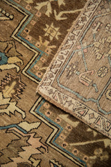 Vintage distressed Karaja rug folded corner, showing textured pile and hand-knotted foundation.