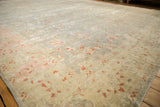 Distressed Sivas carpet detail with faded silver, blush pink, and ivory floral vinery.