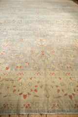 Distressed vintage Sivas rug close-up: faded silver, blush pink, cinnabar floral cross-sections.