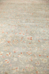 Distressed Sivas rug detail: worn pile, faded silver, blush, soft cinnabar floral vinery.
