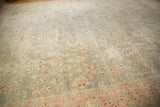 Distressed vintage Sivas carpet with worn silver field, blush border, and faded floral vinery.