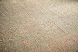 Distressed Sivas field shows delicate floral vinery, blush pink, silver, and even wear.