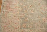 Vintage distressed Sivas rug: blush pink border, oxidized silver field, subtle floral vinery.