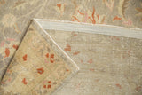 Vintage distressed Sivas carpet corner revealing worn floral pile, faint foundation, and hand-knotted back.