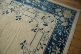 Antique Chinese Peking rug detail: delicate blue floral vinery on ivory field and blue border.