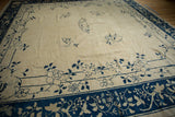 Antique Peking carpet corner featuring cobalt blue blossomed roses and delicate vinery on ivory.