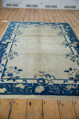 Vintage Peking rug, open ivory center with inwardly sprawling cobalt blue floral border.
