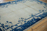 Vintage Peking rug corner with cobalt blue floral border and intact side cord selvage.