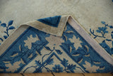 Vintage Peking rug corner revealing blue floral design, hand-knotted foundation, and intact selvage.
