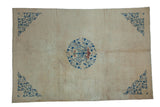 Antique Peking carpet with a central blue roundel medallion and scrolling spandrels on an ivory open field.