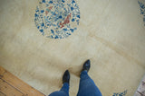 Close view of the antique Peking carpet's even, short pile and central floral roundel.