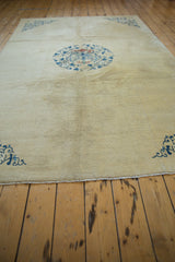 Low angle view across the even, short pile of an antique Peking rug's ivory field.