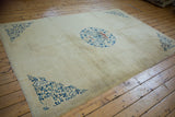Spacious ivory field and blue corner spandrels of an antique Peking carpet from a high angle.