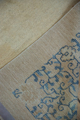 Backside view of an antique Peking carpet showing the hand-knotted construction and short ivory pile.