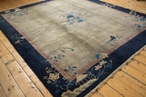 Intricate central infinity knot and pinwheel design with cobalt blue and dusty mauve blossoms on a vintage Peking carpet.