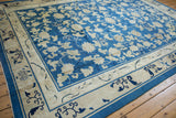 Antique Peking carpet's intricate beige main border with cobalt blue cloudband and rhinoceros horn motifs.