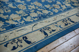Antique Peking rug border featuring cobalt blue cloudband and rhinoceros horn motifs on ivory.