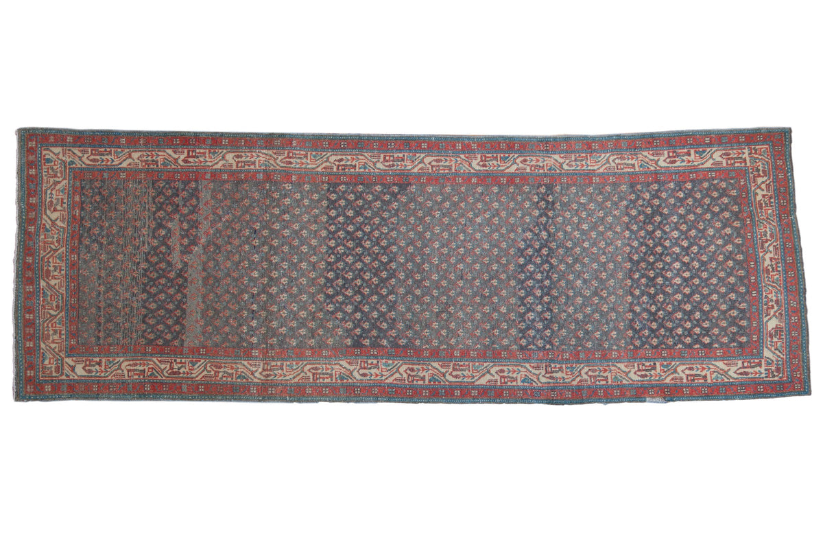 Vintage distressed Persian Serbend runner with an allover boteh pattern in sapphire blue, ruby red, and ivory.