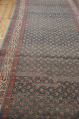 Angled view of a Serbend runner's low pile, showing color abrashes and repeating boteh design.
