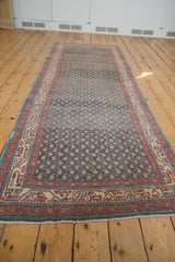 Perspective view of a vintage Serbend runner showing its time-softened boteh pattern and abrashes.