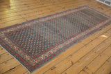 Angled view of a distressed Serbend runner, showcasing the full length and time-softened blue field.