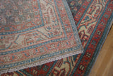Close-up of the hand-knotted reverse and secured side cord on a distressed Persian runner.