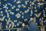 Antique Chinese Peking carpet: dense ivory blossoms, butterflies, vinery, indigo blue abrashes.
