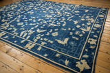 Antique Peking carpet, indigo blue field, ivory butterflies, blossoms, vinery, and subtle abrashes.