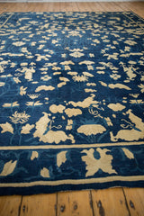 Antique Peking carpet, ivory blossoms, butterflies, and vinery on cobalt blue field.
