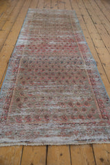 Distressed Malayer runner rug, showing worn areas and faded blush and silver boteh design.
