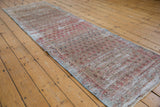 Distressed vintage Malayer runner featuring repeating boteh motifs in pale grapefruit red and oxidized silver tones.