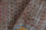 Distressed Malayer runner detail with exposed foundation and blush boteh patterns.