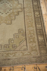 Distressed Oushak rug border shows tone-on-tone geometric patterns and softened pile.