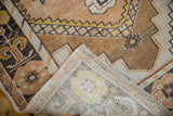 Folded vintage Oushak runner showing distressed pile, hand-knotted reverse, and side selvage.