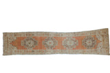 Distressed vintage Oushak rug runner with single column of stepped medallions, terra cotta, beige, and oxidized silver tones, 3'4