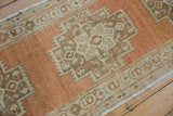 Distressed terracotta and beige stepped geometric patterns with visible even wear.
