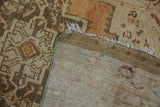 Vintage Oushak rug runner's hand-knotted foundation, fringed edge, and distressed pile.