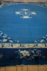 Vintage Peking carpet border with navy, ivory, light blue floral designs and fringed edge.