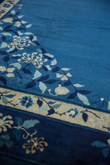 Corner spandrel of vintage Chinese Peking carpet with indigo, cobalt, ivory blossoms.