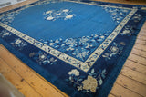 Corner of vintage Peking carpet, densely ornamented with indigo and ivory blossoms.