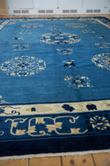 Vibrant blue Peking carpet section with ivory floral roundels, butterflies, and meandering vine border.