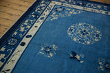 Floral bouquet and butterfly motif on the sky blue field of the vintage Peking carpet.