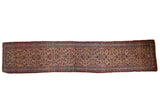 Antique Bijar runner with an allover floral motif in sapphire blue and wine red over a sand colored field.