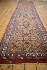 The antique Bijar runner's long profile and balanced repeating floral motif.