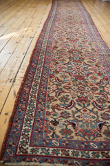 Long view of an antique Persian Bijar runner showing the allover pattern of interlaced vinery.