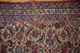 Detail of the antique Bijar runner's border showing time-softened wear and visible foundation.