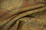 Artful folds of the distressed vintage Oushak carpet, showcasing its worn gold and aubergine pile.