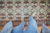 Overhead view of the floral lattice pattern and short pile texture on a vintage Oushak rug.