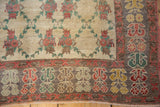 Textured low pile and corner detail of a vintage Oushak rug with a floral lattice field and slate border.